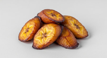 Dried banana slices isolated on white background. Selective focus.の素材