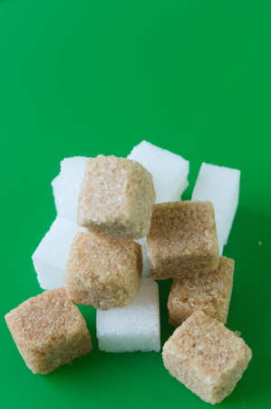 Cube of white and brown sugar on a green background. Green screen background.の写真素材