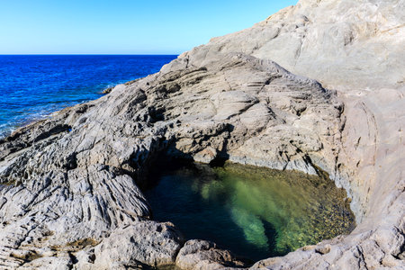 unusual rock formations of the volcanic cliff on Cala Sapone beach, quartz-trachitic ignimbrites.の写真素材