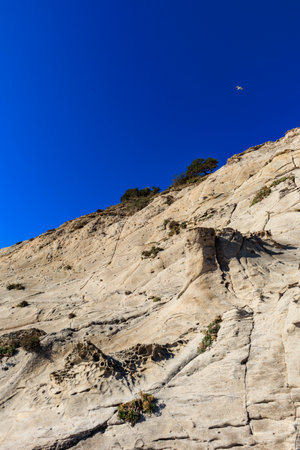 unusual rock formations of the volcanic cliff on Cala Sapone beach, quartz-trachitic ignimbrites.の写真素材