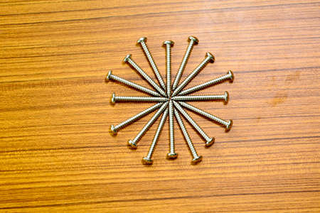 Salf tapping screw on a wood background.の写真素材