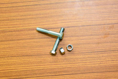 Hex head screw on a wood background.の写真素材