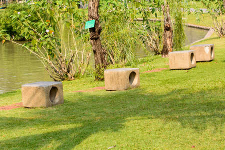 Rock chairs in garden on a nature background.
