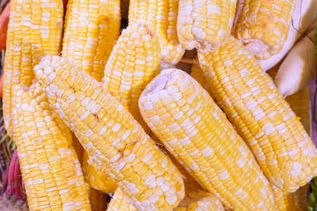 The corn stacks wait for a sale.