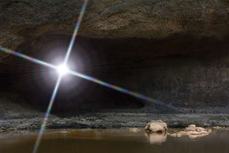 The sun light through the dark cave.の写真素材