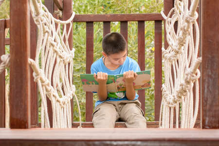 Children read books in the children's play park.の写真素材