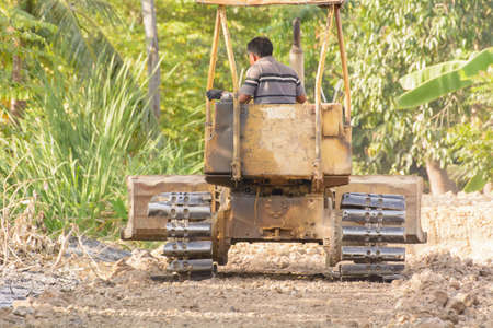 Bulldozer is smooth soil in the garden.の写真素材