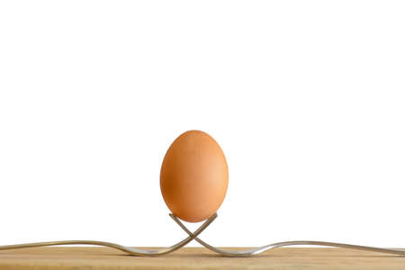 Egg on a fork on a wooden floor.の写真素材