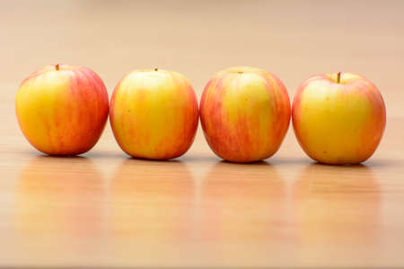 Many apples on the wood table.