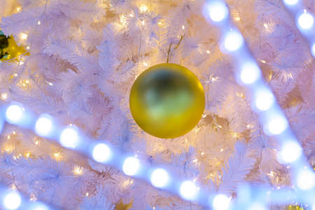The Xmas ball and led on rainbow new year background.