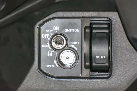 Black motorcycle control panel for starting, Lod car, open seating.