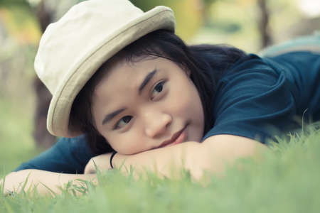 Young woman lying on grass in the park.の写真素材