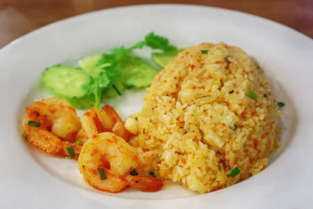 Fried Rice with Shrimp Paste in white dish on the wooden floor.の写真素材