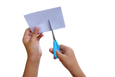 A girl is using scissors of paper cutting on a white backgrounds.の写真素材
