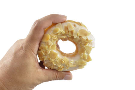 The hand is caught a doughnut isolated on a white background.