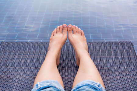 A girl showing legs on a canvas bed.の写真素材