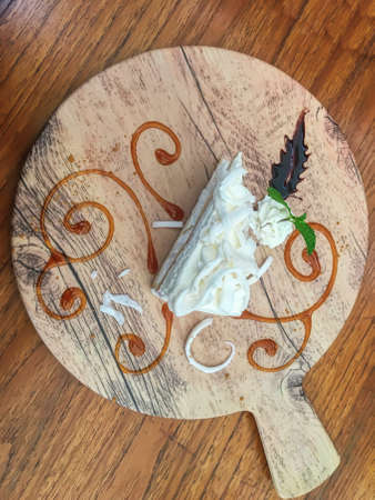 White chocolate cake on the wood background.