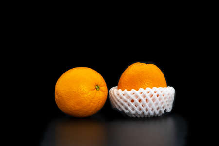 A fresh and healthy the orange on a black background.の写真素材