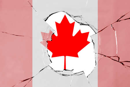 Flag of Canada on a on glass breakage.の写真素材