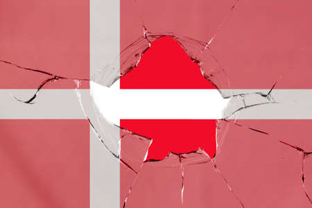 Flag of Denmark on a on glass breakage.の写真素材