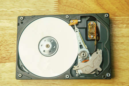 Hard disk drive removable case for repair on the wooden desk.