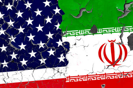Flags of USA and Iran on the old wall on the ropes/usa iran war concept.の写真素材