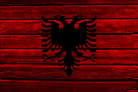 3D Flag of Albania on a old wood wall background.の写真素材