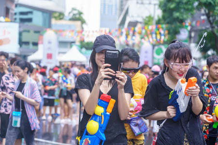 Siam Square, Bangkok, Thailand - APR 13, 2019: short action of people joins celebrations of the Thai New Year or Songkran in Siam Square.のeditorial素材