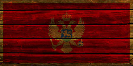 3D Flag of Montenegro on a old wood wall background.の写真素材