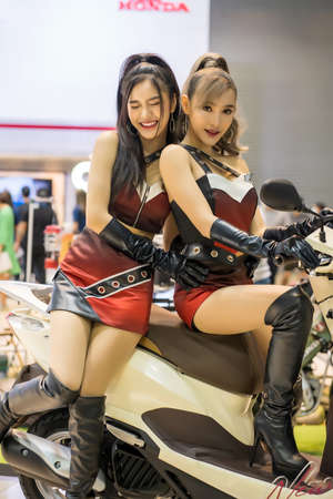 Nonthaburi, Thailand - MAR 27, 2021: Unidentified model poses with a car at The 42th Bangkok International Motor Show Thailand 2021 at IMPACT Arena, Muang Thong Thani, Nonthaburi, Thailand.のeditorial素材