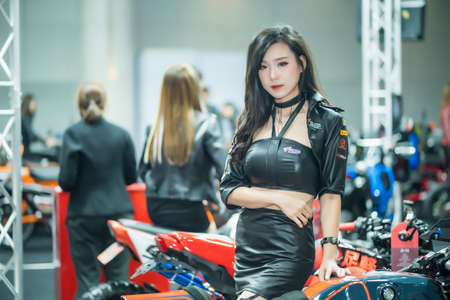 Nonthaburi, Thailand - DEC 12, 2020: Unidentified model poses with a car at The 37th Motor Expo Thailand 2020 at IMPACT Arena, Muang Thong Thani, Nonthaburi, Thailand.のeditorial素材