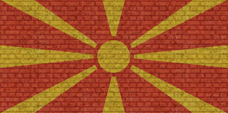 3D Flag of North Macedonia on a old brick wall background.の写真素材