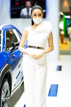 Nonthaburi, Thailand - DEC 4, 2021 - Unidentified model poses with a car at The 38th Motor Expo Thailand 2021 at IMPACT Arena, Muang Thong Thani, Nonthaburi, Thailand.のeditorial素材