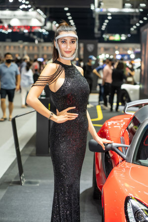Nonthaburi, Thailand - DEC 4, 2021 - Unidentified model poses with a car at The 38th Motor Expo Thailand 2021 at IMPACT Arena, Muang Thong Thani, Nonthaburi, Thailand.のeditorial素材