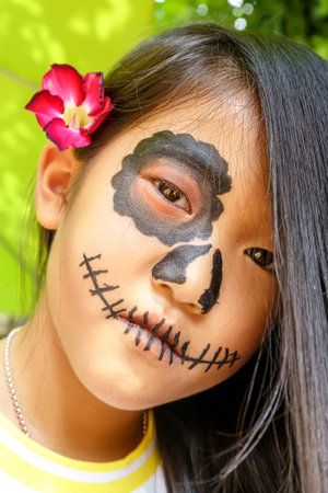 Close up the attractive girl in the sugar skull makeup. Day of The Dead. Halloween.