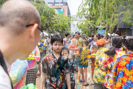Siam Square, Bangkok, Thailand - APR 13, 2023 Songkran Festival, The short action of people joins celebrations of the Thai New Year or Songkran in Siam Square Bangkok, Thailand.のeditorial素材