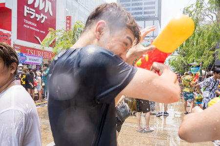 Siam Square, Bangkok, Thailand - APR 13, 2023 Songkran Festival, The short action of people joins celebrations of the Thai New Year or Songkran in Siam Square Bangkok, Thailand.のeditorial素材
