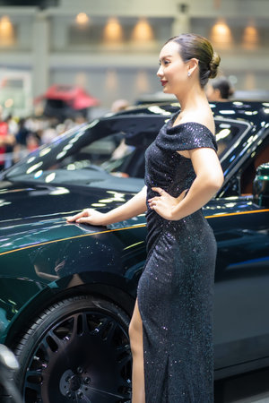 Nonthaburi, Thailand - MAR 26, 2023 Unidentified model poses with a car at The 44th Bangkok international motor show 2023 at IMPACT Arena, Muang Thong Thani, Nonthaburi, Thailand.のeditorial素材