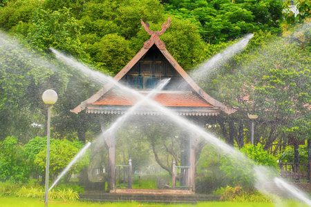 The sprinklers in the park are working.の写真素材