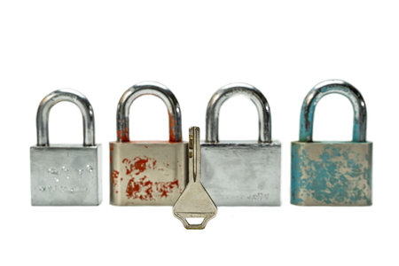 4 padlocks and 1 key isolated on a white background.の写真素材