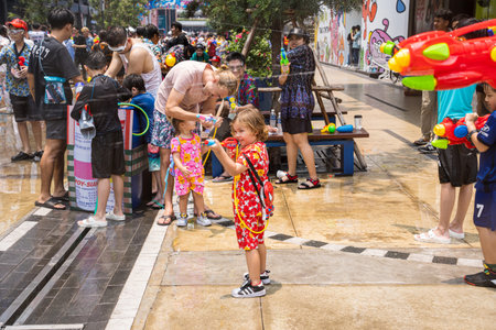 Siam Square, Bangkok, Thailand - APR 13, 2023 Songkran Festival, The short action of people joins celebrations of the Thai New Year or Songkran in Siam Square Bangkok, Thailand.のeditorial素材