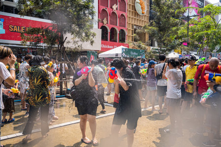 Siam Square, Bangkok, Thailand - APR 13, 2023 Songkran Festival, The short action of people joins celebrations of the Thai New Year or Songkran in Siam Square Bangkok, Thailand.のeditorial素材