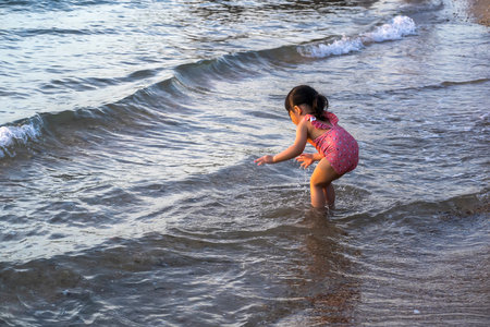 Girl playing in the water at the beach.の写真素材
