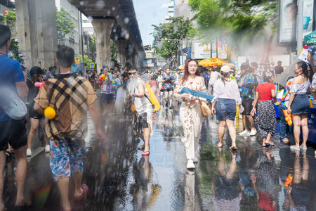 Silom, Bangkok, Thailand - APR 12, 2025 Songkran Festival, The short action of people joins celebrations of the Thai New Year. There was splashing and powdering. People getting soaked during Songkran.のeditorial素材