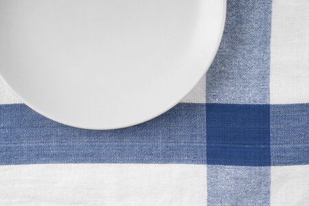 Empty plate at classic checkered tableclothの写真素材