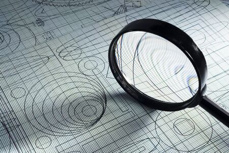 drawing, graph paper and magnifying glass, selective focusの写真素材