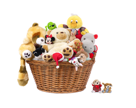 Stuffed animal toys in a basket isolated on a white のeditorial素材