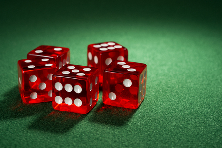 Red dice on a green feltの写真素材