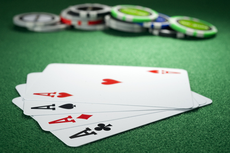 Four aces and chips on a green feltの写真素材