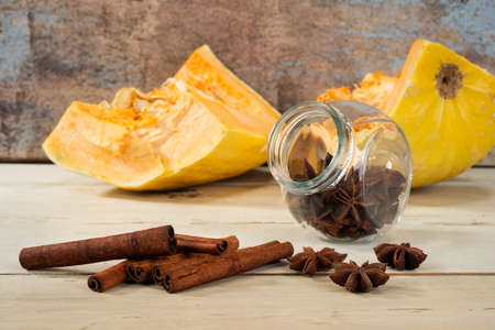 anise, cinamon and sliced pumpkin on wooden tableの写真素材